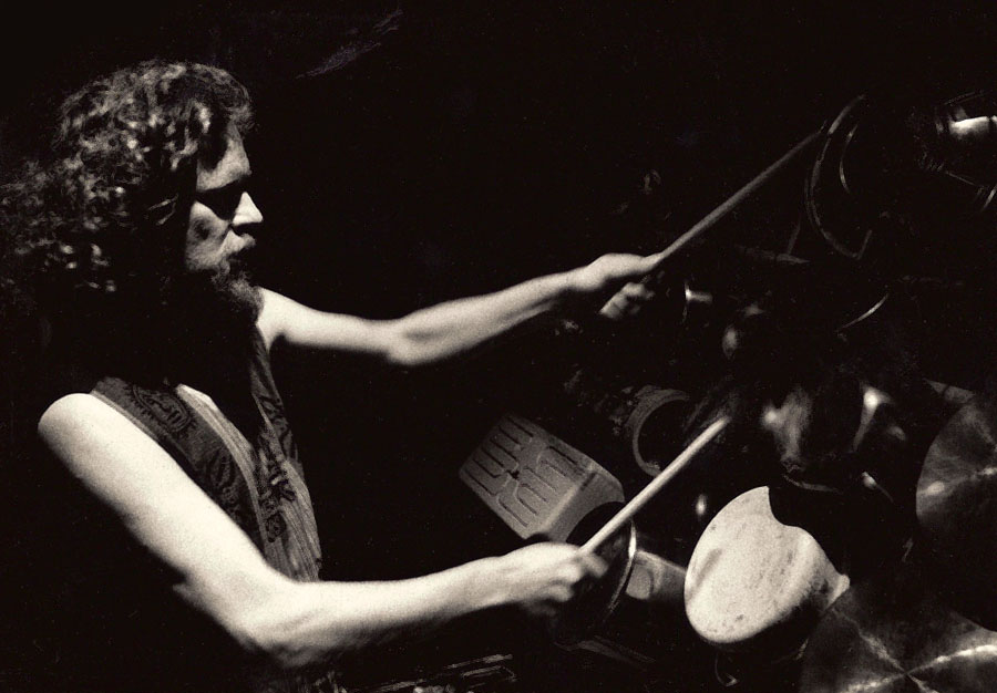Profile shot of Adrian Freedman playing drums in Odin